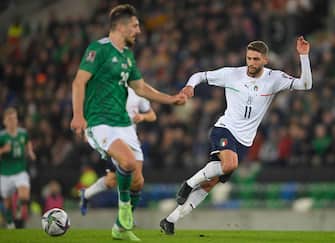 epa09584176 Italy s Domenico Berardi (R) in action against Northern Ireland's Craig Cathcart (L) during the FIFA World Cup 2022 group C qualifying soccer match between Northern Ireland and Italy in Belfast, Britain, 15 November 2021.  EPA/MARK MARLOW