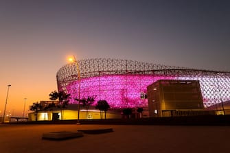 AL RAYYAN, QATAR - OCTOBER 08: An exterior general sunset view of the Ahmed bin Ali Stadium, popularly known as the Al-Rayyan Stadium, a host venue for the Qatar 2022 FIFA World Cup. Built on the site of a venue with the same name, it incorporates symbols of Qatari culture into its spectacular undulating faÃ§ade. The facilities surrounding the stadium also mirror the country, with sand dune-shaped structures recalling the beautifully wild lands to the west. It is situated near the Mall of Qatar, on October 7, 2021 in Doha, Qatar. (Photo by Robbie Jay Barratt - AMA/Getty Images)