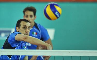 Italian player Roberto Cazzaniga spikes the ball against Tunisian volley-team during a semi-final volleyball match Italy-Tunisia at the 2009 XVI Mediterranean Games in Chieti, on July 4, 2009. Italy  won 3-0.  AFP PHOTO /ANDREAS SOLARO (Photo credit should read ANDREAS SOLARO/AFP via Getty Images)