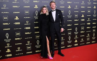 AC Milan's Danish defender Simon Kjaer (R) and his wife Elina Gollert pose upon arrival to attend the 2021 Ballon d'Or France Football award ceremony at the Theatre du Chatelet in Paris on November 29, 2021. (Photo by Anne-Christine POUJOULAT / AFP) (Photo by ANNE-CHRISTINE POUJOULAT/AFP via Getty Images)
