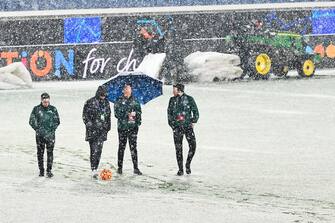 Match officials inspect the pitch to assess playing possibilities as snow continues falling ahead the UEFA Champions League Group F football match between Atalanta and Villarreal on December 8, 2021 at the Atleti Azzurri d'Italia stadium in Bergamo. (Photo by Isabella BONOTTO / AFP) (Photo by ISABELLA BONOTTO/AFP via Getty Images)