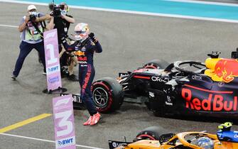 epa09636204 Dutch Formula One driver Max Verstappen (3-L) of Red Bull Racing reacts after taking the pole position during the qualifying session of the Formula One Grand Prix of Abu Dhabi at Yas Marina Circuit in Abu Dhabi, United Arab Emirates, 11 December 2021. The Formula One Grand Prix of Abu Dhabi will take place on 12 December 2021.  EPA/Ali Haider