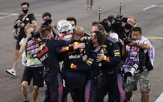 ABU DHABI, UNITED ARAB EMIRATES - DECEMBER 12: Race winner Max Verstappen of Netherlands and Red Bull Racing celebrates with his team in parc ferme during the F1 Grand Prix of Abu Dhabi at Yas Marina Circuit on December 12, 2021 in Abu Dhabi, United Arab Emirates. (Photo by Lars Baron/Getty Images)