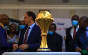 The trophy of the African Cup of Nations, presented on December 7, 2021 by the General Manager of Total Energie in Cameroon Adrien Bechonnet to Narcisse Mouelle Kombi, Cameroonian Minister of Sports and Physical Education. The 33rd edition of the African Cup of Nations will be held in Cameroon from January 9 to February 6, 2022. (Photo by Daniel Beloumou Olomo / AFP) (Photo by DANIEL BELOUMOU OLOMO/AFP via Getty Images)