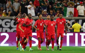 HOUSTON, TX - JULY 29: Tajon Buchanan #12 of Canada celebrates with his teammates after scoring his team's first goal during the semifinal match between Mexico and Canada as part of 2021 CONCACAF Gold Cup at NRG Stadium on July 29, 2021 in Houston, Texas. (Photo by Omar Vega/Getty Images)