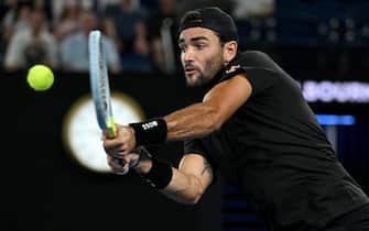 epa09707729 Matteo Berrettini of Italy plays a shot during his Men s singles quarterfinal match against Gael Monfils of France at the Australian Open Grand Slam tennis tournament at Melbourne Park, in Melbourne, Australia, 25 January 2022.  EPA/DEAN LEWINS AUSTRALIA AND NEW ZEALAND OUT