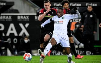 Freiburg's Ermedin Demirovic (L) in action against Moenchengladbach's Denis Zakaria (R) during the German Bundesliga soccer match between Borussia Moenchengladbach and SC Freiburg in Moenchengladbach, Germany, 05 December 2021. ANSA/SASCHA STEINBACH CONDITIONS - ATTENTION: The DFL regulations prohibit any use of photographs as image sequences and/or quasi-video.