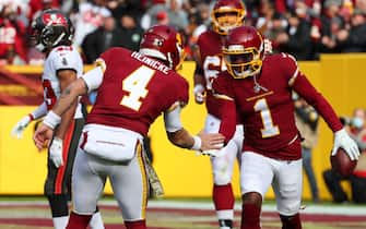 Nov 14, 2021; Landover, MD USA;  Washington Football Team quarterback Taylor Heinicke (4) celebrates a touchdown with wide receiver DeAndre Carter (1) during an NFL game at FedEx Field. Washington beat the Tampa Bay Buccaneers 29-19. (Steve Jacobson/Image of Sport/Sipa USA)