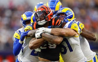 epa09754437 Cincinnati Bengals running back Joe Mixon (center) is tackled during the first half of Super Bowl LVI at SoFi Stadium in Inglewood, California, USA, 13 February 2022. The annual Super Bowl is the Championship game of the NFL between the AFC Champion and the NFC Champion and has been held every year since January of 1967.  EPA/JOHN G. MABANGLO