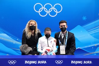 BEIJING, CHINA - FEBRUARY 17: Kamila Valieva of Team ROC reacts to their score with choreographer Daniil Gleikhengauz (R) and coach Eteri Tutberidze (L) after the Women Single Skating Free Skating on day thirteen of the Beijing 2022 Winter Olympic Games at Capital Indoor Stadium on February 17, 2022 in Beijing, China. (Photo by Matthew Stockman/Getty Images)