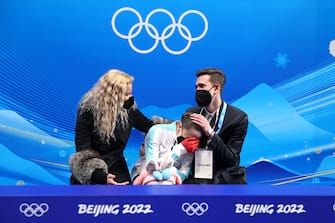BEIJING, CHINA - FEBRUARY 17: Kamila Valieva of Team ROC reacts to their score with choreographer Daniil Gleikhengauz (R) and coach Eteri Tutberidze (L) after the Women Single Skating Free Skating on day thirteen of the Beijing 2022 Winter Olympic Games at Capital Indoor Stadium on February 17, 2022 in Beijing, China. (Photo by Matthew Stockman/Getty Images)