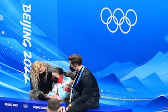 BEIJING, CHINA - FEBRUARY 17: Kamila Valieva of Team ROC reacts to their score with choreographer Daniil Gleikhengauz (R) and coach Eteri Tutberidze (L) after the Women Single Skating Free Skating on day thirteen of the Beijing 2022 Winter Olympic Games at Capital Indoor Stadium on February 17, 2022 in Beijing, China. (Photo by David Ramos/Getty Images)