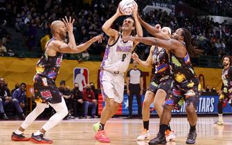CLEVELAND, OHIO - FEBRUARY 18: Gianmarco Tamberi shoots over Matt James and Kareem Hunt during the Ruffles NBA All-Star Celebrity Game during the 2022 NBA All-Star Weekend at Wolstein Center on February 18, 2022 in Cleveland, Ohio. NOTE TO USER: User expressly acknowledges and agrees that, by downloading and or using this photograph, User is consenting to the terms and conditions of the Getty Images License Agreement.   Tim Nwachukwu/Getty Images/AFP
== FOR NEWSPAPERS, INTERNET, TELCOS & TELEVISION USE ONLY ==