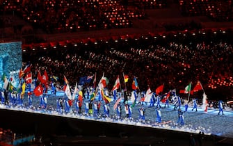 epa09773991 The entry of the flags of the participating nations during the Closing Ceremony for the Beijing 2022 Olympic Games at the National Stadium, also known as Bird's Nest, in Beijing China, 20 February 2022.  EPA/FAZRY ISMAIL