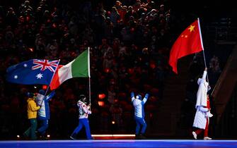 (From L) Australia's flag bearer Sammy Kennedy-Sim, Italy's flag bearer Francesca Lollobrigida and China's flag bearer Gao Tingyu parade during the closing ceremony of the Beijing 2022 Winter Olympic Games, at the National Stadium, known as the Bird's Nest, in Beijing, on February 20, 2022. (Photo by Anne-Christine POUJOULAT / AFP) (Photo by ANNE-CHRISTINE POUJOULAT/AFP via Getty Images)