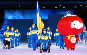 BEIJING, CHINA - MARCH 04: Flag bearer Maksym Yarovyi of Team Ukraine leads their team out during the Opening Ceremony of the Beijing 2022 Winter Paralympics at the Beijing National Stadium on March 04, 2022 in Beijing, China. (Photo by Ryan Pierse/Getty Images)