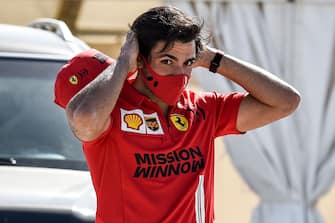 Ferrari's Spanish driver Carlos Sainz Jr looks on as he arrives at the circuit before the start of the third day of the Formula One (F1) pre-season testing at the Bahrain International Circuit in the city of Sakhir on March 14, 2021. (Photo by Mazen MAHDI / AFP) (Photo by MAZEN MAHDI/AFP via Getty Images)