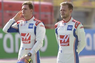 Haas' German driver Mick Schumacher (L) and Haas' Danish driver Kevin Magnussen pose for a picture during the first day of Formula One (F1) pre-season testing at the Bahrain International Circuit in the city of Sakhir on March 12, 2021. (Photo by Mazen Mahdi / AFP) (Photo by MAZEN MAHDI/AFP via Getty Images)