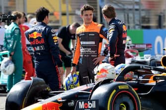 McLaren's British driver Lando Norris (C) speaks with Red Bull's Dutch driver Max Verstappen (R) and Red Bull's Mexican driver Sergio Perez during the first day of Formula One (F1) pre-season testing at the Bahrain International Circuit in the city of Sakhir on March 12, 2021. (Photo by Mazen MAHDI / AFP) (Photo by MAZEN MAHDI/AFP via Getty Images)