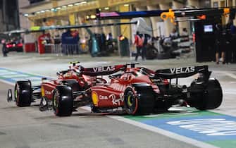 Ferrari's Monegasque driver Charles Leclerc (L) and Ferrari's Spanish driver Carlos Sainz Jr leave the pits during the qualifying session on the eve of the Bahrain Formula One Grand Prix at the Bahrain International Circuit in the city of Sakhir on March 19, 2022. (Photo by Giuseppe CACACE / POOL / AFP) (Photo by GIUSEPPE CACACE/POOL/AFP via Getty Images)