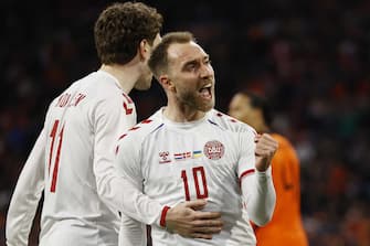 epa09852035 Christian Eriksen (R) of Denmark celebrates with teammate Andreas Skov Olsen after scoring his team's second goal during the International friendly soccer match between The Netherlands and Denmark at the Johan Cruijff ArenA in Amsterdam, Netherlands, 26 March 2022.  EPA/MAURICE VAN STEEN