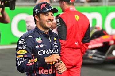 Red Bull's Mexican driver Sergio Perez smiles after finishing in pole position after the qualifying session on the eve of the 2022 Saudi Arabia Formula One Grand Prix at the Jeddah Corniche Circuit on March 26, 2022. (Photo by ANDREJ ISAKOVIC / AFP) (Photo by ANDREJ ISAKOVIC/AFP via Getty Images)