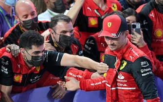 Ferrari's Monegasque driver Charles Leclerc (R) celebrates with his team after the 2022 Saudi Arabia Formula One Grand Prix at the Jeddah Corniche Circuit on March 27, 2022. (Photo by ANDREJ ISAKOVIC / AFP) (Photo by ANDREJ ISAKOVIC/AFP via Getty Images)