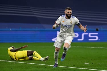Real Madrid's French forward Karim Benzema celebrates after scoring a goal during the UEFA Champions League quarter final second leg football match between Real Madrid CF and Chelsea FC at the Santiago Bernabeu stadium in Madrid on April 12, 2022. (Photo by PIERRE-PHILIPPE MARCOU / AFP) (Photo by PIERRE-PHILIPPE MARCOU/AFP via Getty Images)