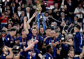 Inter players celebrate with the winner's trophy after Inter won the Italian Cup (Coppa Italia) final football match between Juventus and Inter on May 11, 2022 at the Olympic stadium in Rome. (Photo by Filippo MONTEFORTE / AFP) (Photo by FILIPPO MONTEFORTE/AFP via Getty Images)