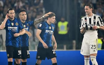Inter Milan's Argentine forward Lautaro Martinez (2ndL) congratulates Inter Milan's Italian midfielder Nicolo Barella afetr he opened the scoring during the Italian Cup (Coppa Italia) final football match between Juventus and Inter on May 11, 2022 at the Olympic stadium in Rome. (Photo by Isabella BONOTTO / AFP) (Photo by ISABELLA BONOTTO/AFP via Getty Images)