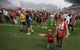 Fans take to the pitch to celebrate after AC Milan won the Italian Serie A football match between Sassuolo and AC Milan, securing the "Scudetto" championship on May 22, 2022 at the Mapei - Citta del Tricolore stadium in Sassuolo. (Photo by Filippo MONTEFORTE / AFP) (Photo by FILIPPO MONTEFORTE/AFP via Getty Images)