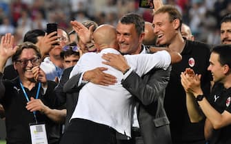 AC Milan's Italian head coach Stefano Pioli (L) embraces AC Milan's former player turned technical director, Paolo Maldini during the winner's trophy ceremony after AC Milan won the Italian Serie A football match between Sassuolo and AC Milan, securing the "Scudetto" championship on May 22, 2022 at the Mapei - Citta del Tricolore stadium in Sassuolo. (Photo by Tiziana FABI / AFP) (Photo by TIZIANA FABI/AFP via Getty Images)