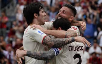 TOPSHOT - AC Milan's French forward Olivier Giroud (C) celebrates with AC Milan's Italian midfielder Sandro Tonali (L) and AC Milan's Italian defender Davide Calabria after scoring his second goal during the Italian Serie A football match between Sassuolo and AC Milan on May 22, 2022 at the Mapei - Citta del Tricolore stadium in Sassuolo. (Photo by Filippo MONTEFORTE / AFP) (Photo by FILIPPO MONTEFORTE/AFP via Getty Images)