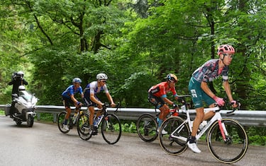 LAVARONE, ITALY - MAY 25: (L-R) Koen Bouwman of Netherlands and Team Jumbo - Visma blue mountain jersey, Mauri Vansevenant of Belgium and Team Quick-Step - Alpha Vinyl, Santiago Buitrago Sanchez of Colombia and Team Bahrain Victorious and Hugh Carthy of United Kingdom and Team EF Education - Easypost compete in the chase group during the 105th Giro d'Italia 2022, Stage 17 a 168 km stage from Ponte di Legno to Lavarone 1161m / #Giro / #WorldTour / on May 25, 2022 in Lavarone, Italy. (Photo by Michael Steele/Getty Images)