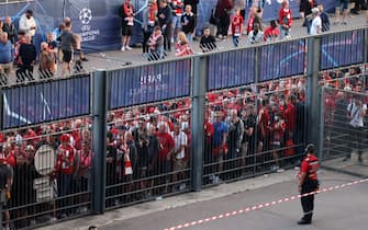 Liverpool fans stand outside prior to the UEFA Champions League final football match between Liverpool and Real Madrid at the Stade de France in Saint-Denis, north of Paris, on May 28, 2022. (Photo by Thomas COEX / AFP) (Photo by THOMAS COEX/AFP via Getty Images)