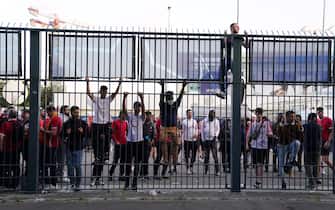 People try to climb gates outside the ground as the kick off is delayed during the UEFA Champions League Final at the Stade de France, Paris. Picture date: Saturday May 28, 2022. (Photo by Adam Davy/PA Images via Getty Images)