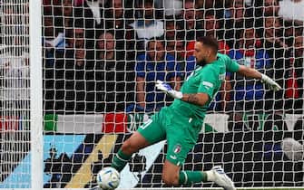 Italy's goalkeeper Gianluigi Donnarumma stops the ball on his goal-line to prevent an own goal during the 'Finalissima' International friendly football match between Italy and Argentina at Wembley Stadium in London on June 1, 2022. - The Azzurri face the South American continental champions in the inaugural Finalissima at Wembley. (Photo by Adrian DENNIS / AFP) (Photo by ADRIAN DENNIS/AFP via Getty Images)