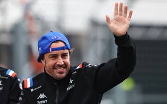 BUDAPEST, HUNGARY - JULY 31: Fernando Alonso of Spain and Alpine F1 waves to the crowd on the drivers parade ahead of the F1 Grand Prix of Hungary at Hungaroring on July 31, 2022 in Budapest, Hungary. (Photo by Bryn Lennon - Formula 1/Formula 1 via Getty Images)
