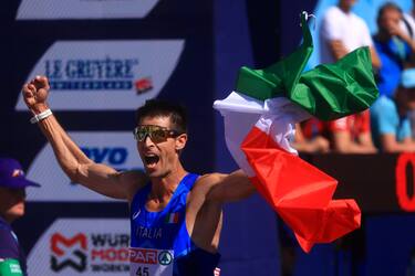 MUNICH, GERMANY - AUGUST 16: Matteo Giupponi of Italy celebrates as he crosses the finish line to win bronze in the Athletics Men's 35km Race Walk competition on day 6 of the European Championships Munich 2022 Koenigsplatz on August 16, 2022 in Munich, Germany. (Photo by Jan Hetfleisch/Getty Images)
