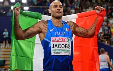 Italy's Lamont Marcell Jacobs celebrates winning a gold in the men's 100m final during the European Athletics Championships at the Olympic Stadium in Munich, southern Germany on August 16, 2022. (Photo by ANDREJ ISAKOVIC / AFP) (Photo by ANDREJ ISAKOVIC/AFP via Getty Images)