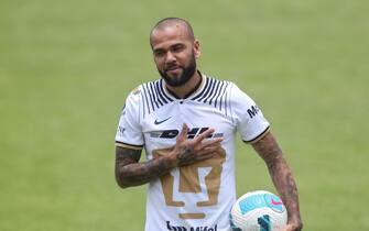epa10088479 Brazilian defender Dani Alves reacts during his presentation as new player of the Pumas socccer team, in Mexico City, Mexico, 23 July 2022. Alves, 39, agreed with Pumas to play the Torneo Apertura as he is focused on being part of the Brazilian national team for the World Cup 2022.  EPA/Sashenka Gutierrez
