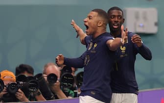 epa10321419 Kylian Mbappe of France celebrates scoring the 3-1 with Ousmane Dembele during the FIFA World Cup 2022 group D soccer match between France and Australia at Al Janoub Stadium in Al Wakrah, Qatar, 22 November 2022.  EPA/Friedemann Vogel