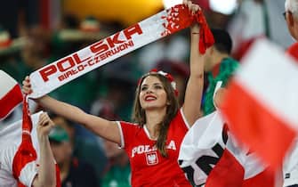 DOHA, QATAR - NOVEMBER 22: Poland fans hold up flags during the FIFA World Cup Qatar 2022 Group C match between Mexico and Poland at Stadium 974 on November 22, 2022 in Doha, Qatar. (Photo by Pawel Andrachiewicz/PressFocus/MB Media/Getty Images)