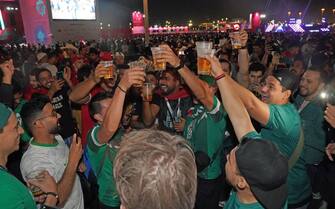 Mexican and Dutch fans enjoy a beer at the FIFA Fan Festival in Al Bidda Park in Doha, Qatar during the FIFA World Cup 2022. Picture date: Sunday November 20, 2022. (Photo by Jonathan Brady/PA Images via Getty Images)