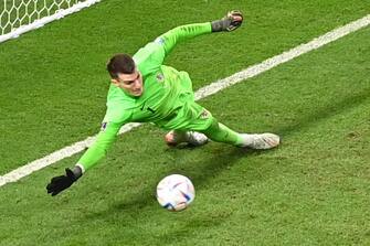 epa10350082 Goalkeeper Dominik Livakovic of Croatia saves the first penalty taken by Kaoru Mitoma of Japan during the FIFA World Cup 2022 round of 16 soccer match between Japan and Croatia at Al Janoub Stadium in Al Wakrah, Qatar, 05 December 2022.  EPA/Georgi Licovski