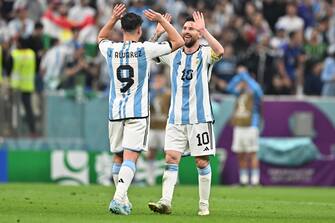 epa10364307 Julian Alvarez (L) of Argentina celebrates with teammate Lionel Messi after scoring the 3-0 during the FIFA World Cup 2022 semi final between Argentina and Croatia at Lusail Stadium in Lusail, Qatar, 13 December 2022.  EPA/Noushad Thekkayil