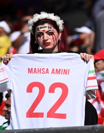 DOHA, QATAR - NOVEMBER 25: A Iran fan wearing blood makeup in protest of Masha Amini's death in Iran during the FIFA World Cup Qatar 2022 Group B match between Wales and IR Iran at Ahmad Bin Ali Stadium on November 25, 2022 in Doha, Qatar. (Photo by Lionel Hahn/Getty Images)