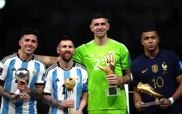 Argentina's Enzo Fernandez, young player award, Lionel Messi, golden ball, goalkeeper Emiliano Martinez, golden glove and France's Kylian Mbappe, golden boot, (left-right) pose with their awards following the FIFA World Cup final at Lusail Stadium, Qatar. Picture date: Sunday December 18, 2022.