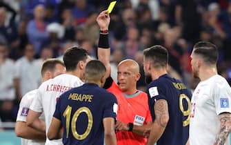 epa10330458 Andreas Christensen of Denmark is shown the yellow card by referee Szymon Marciniak during the FIFA World Cup 2022 group D soccer match between France and Denmark at Stadium 947 in Doha, Qatar, 26 November 2022.  EPA/Abir Sultan