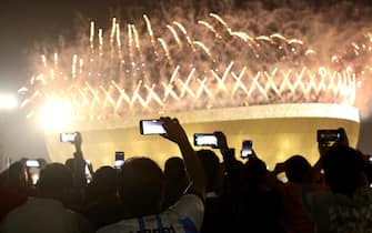 epa10373049 Fans take pics of fireworks above Lusail stadium after the FIFA World Cup 2022 final soccer match between Argentina and France, Lusail, Qatar, 18 December 2022.  EPA/MARTIN DIVISEK
